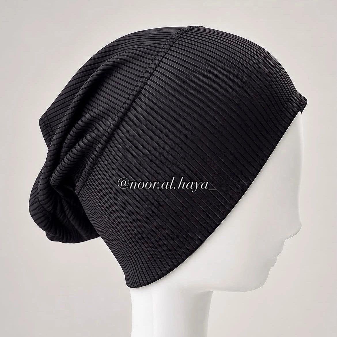 a dummy wearing a black ribbed undercap by noor al haya