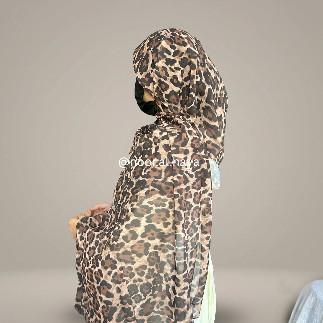 a women wearing leopard print chiffon hijab by noor al haya