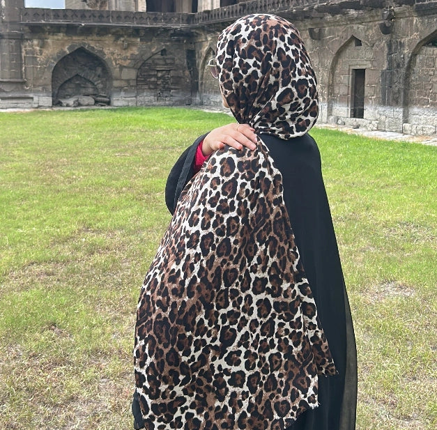Woman wearing a leopard print modal hijab by Noor Al Haya