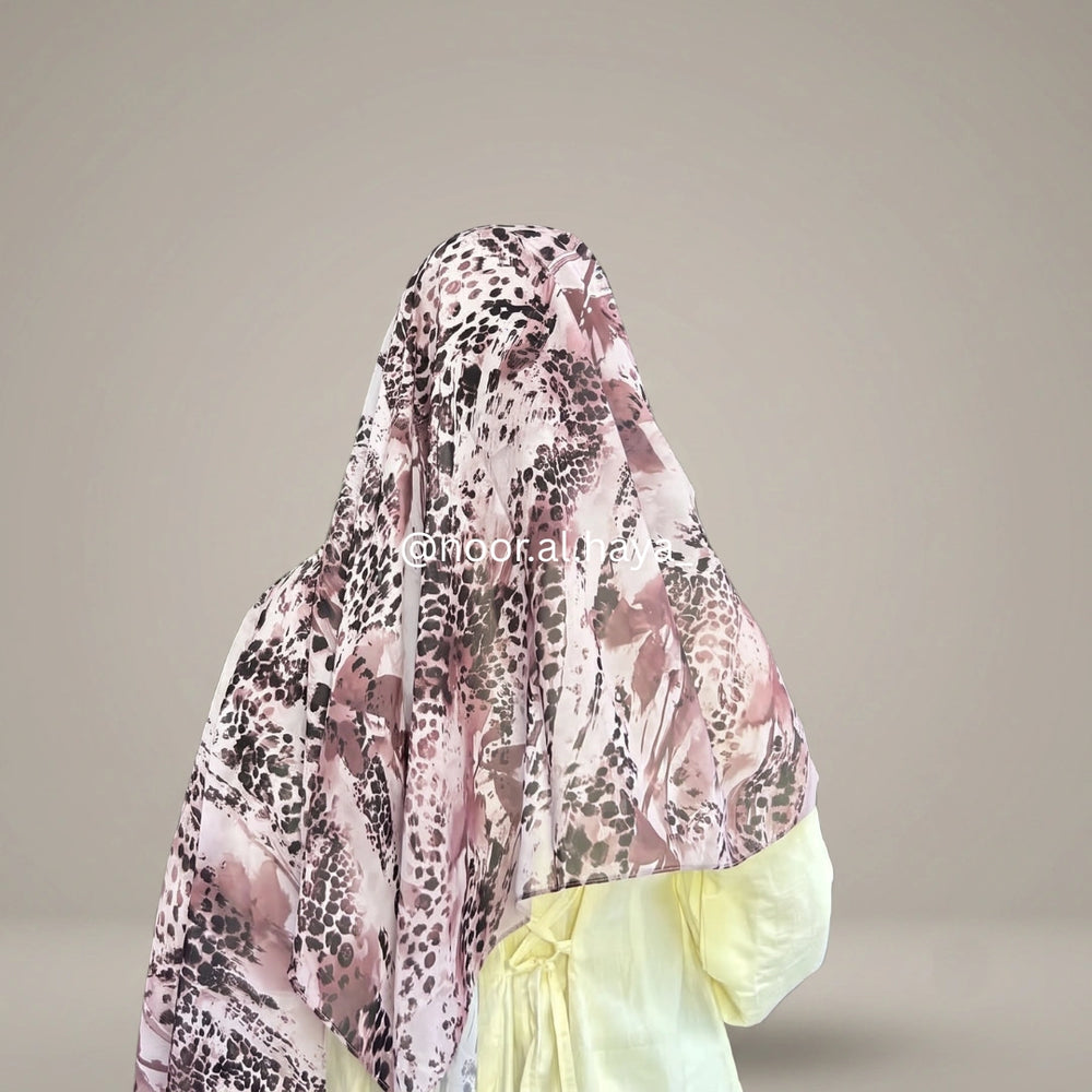a women wearing amethyst panther print hijab by noor al haya