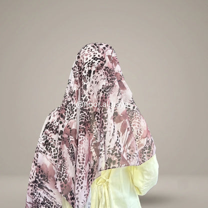 a women wearing amethyst panther print hijab by noor al haya