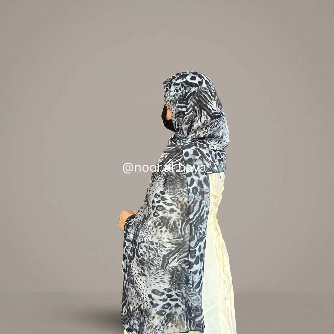 a women wearing midnight jaguar print hijab by noor al haya 