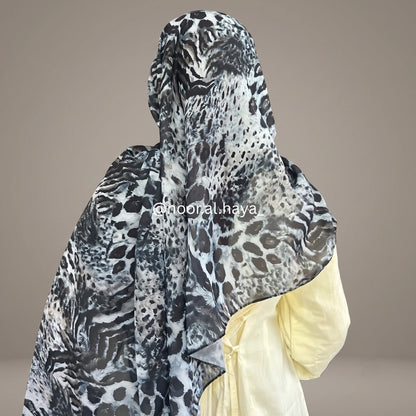 a women wearing midnight jaguar print hijab by noor al haya 