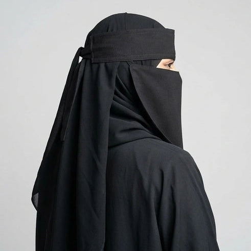 a women wearing and posing 9'12 saudi niqab by noor al haya