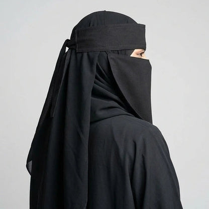 a women wearing and posing 9'12 saudi niqab by noor al haya