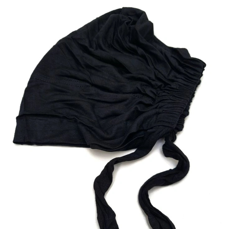 a close up of tie black undercap by noor al haya 