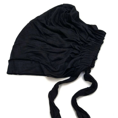 a close up of tie black undercap by noor al haya 