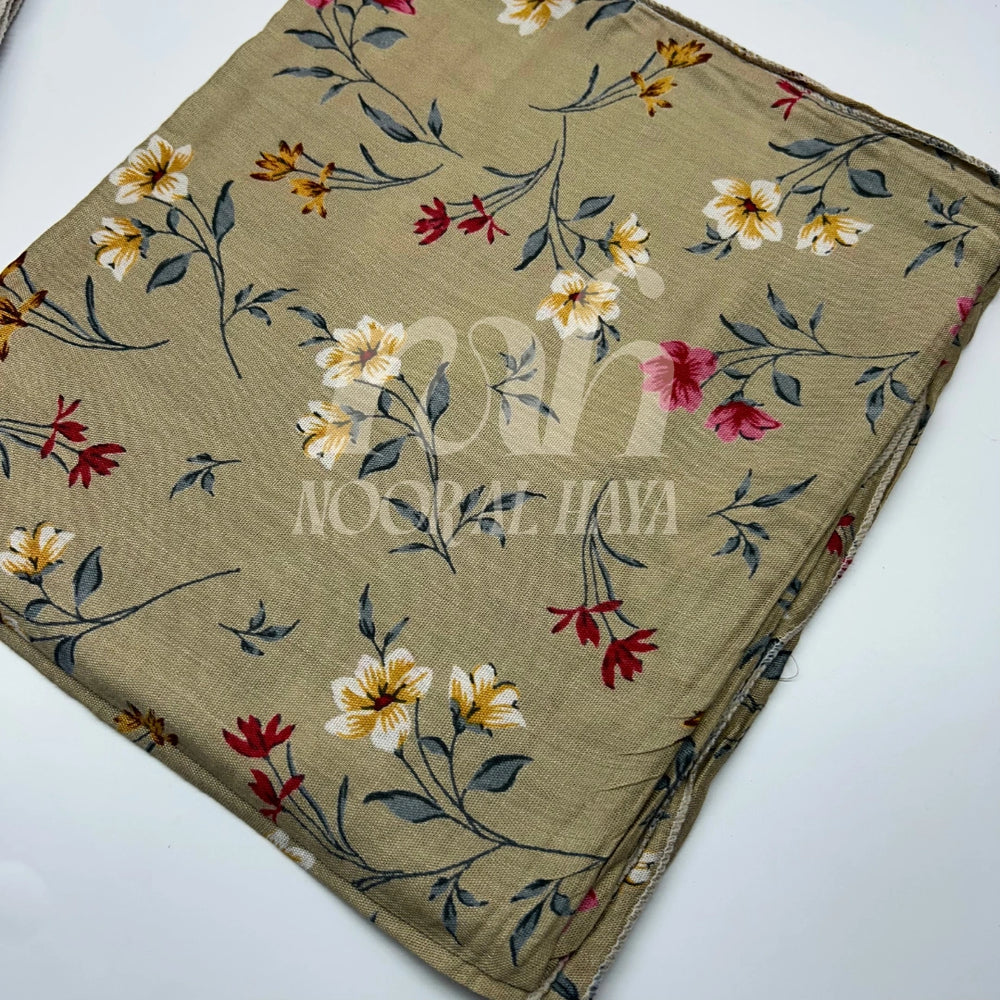 a close up shot of brown floral printed hijab by noor al haya