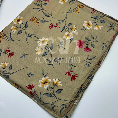 a close up shot of brown floral printed hijab by noor al haya