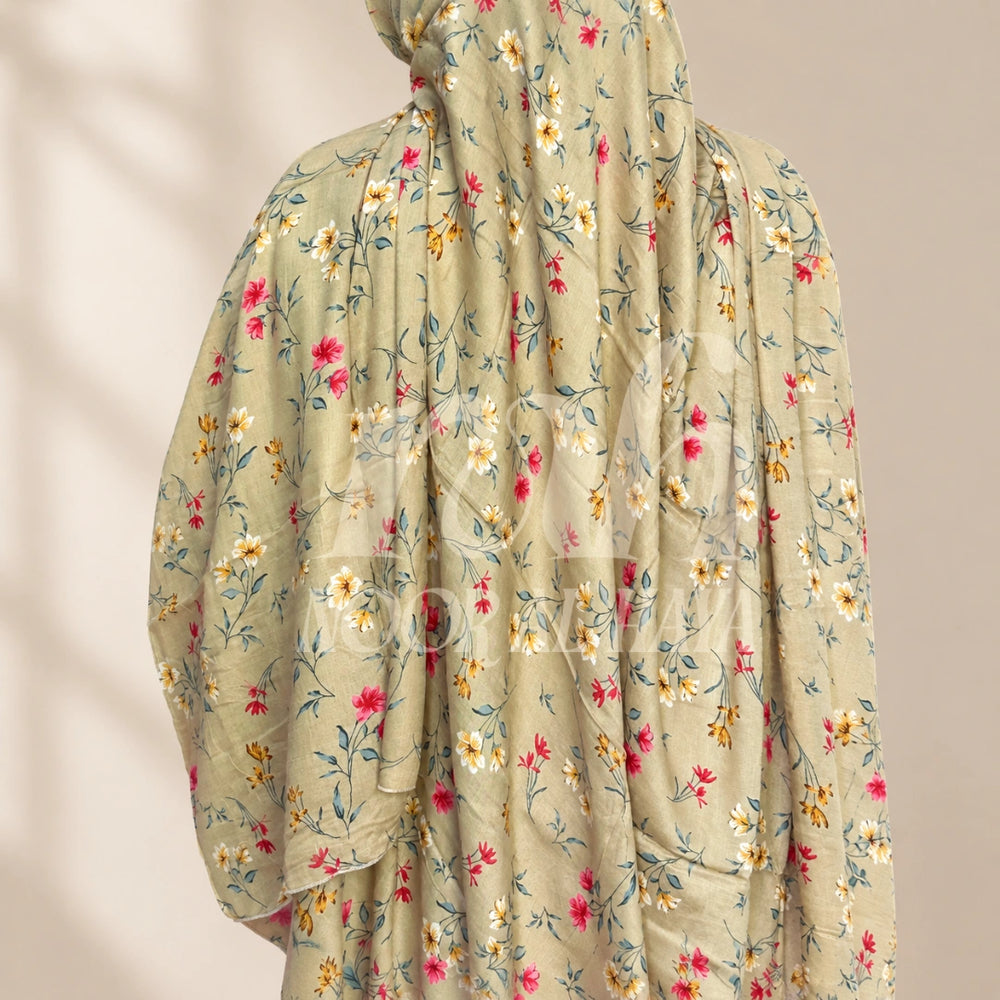 a model wearing brown floral printed hijab by noor al haya