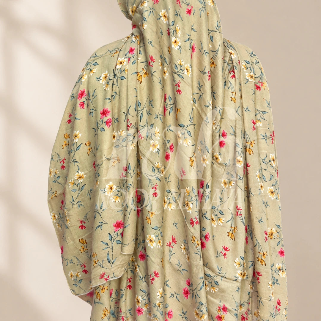 a model wearing brown floral printed hijab by noor al haya