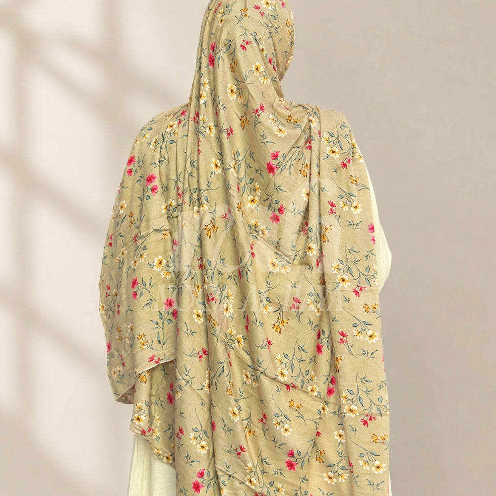 a model wearing brown floral printed hijab by noor al haya