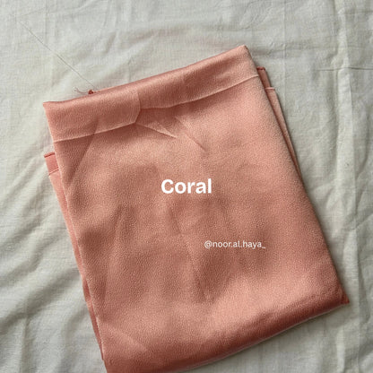 Bubble satin hijab in coral by Noor Al Haya