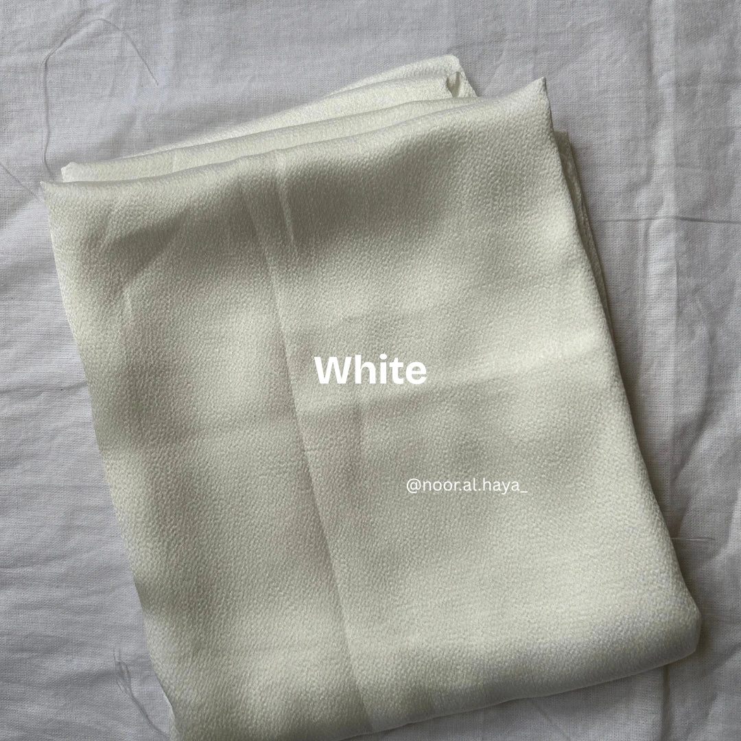 Bubble satin hijab in white by Noor Al Haya