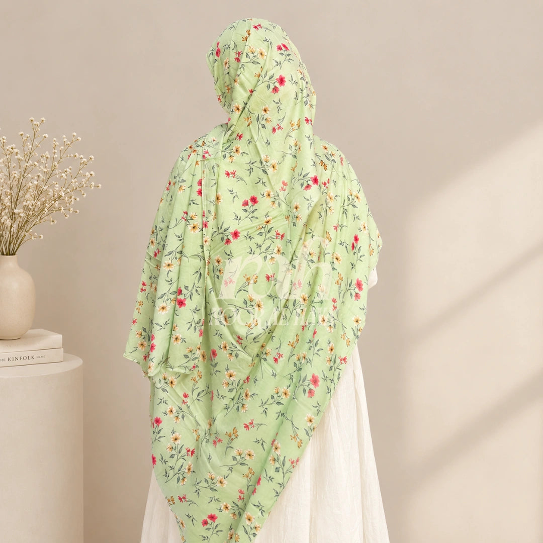 a model wearing green floral printed hijab by noor al haya