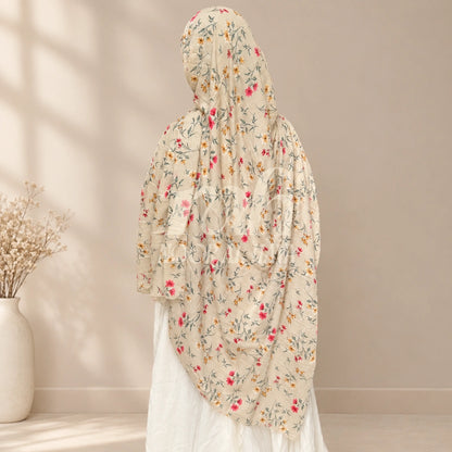 a model wearing ice white floral printed hijab by noor al haya