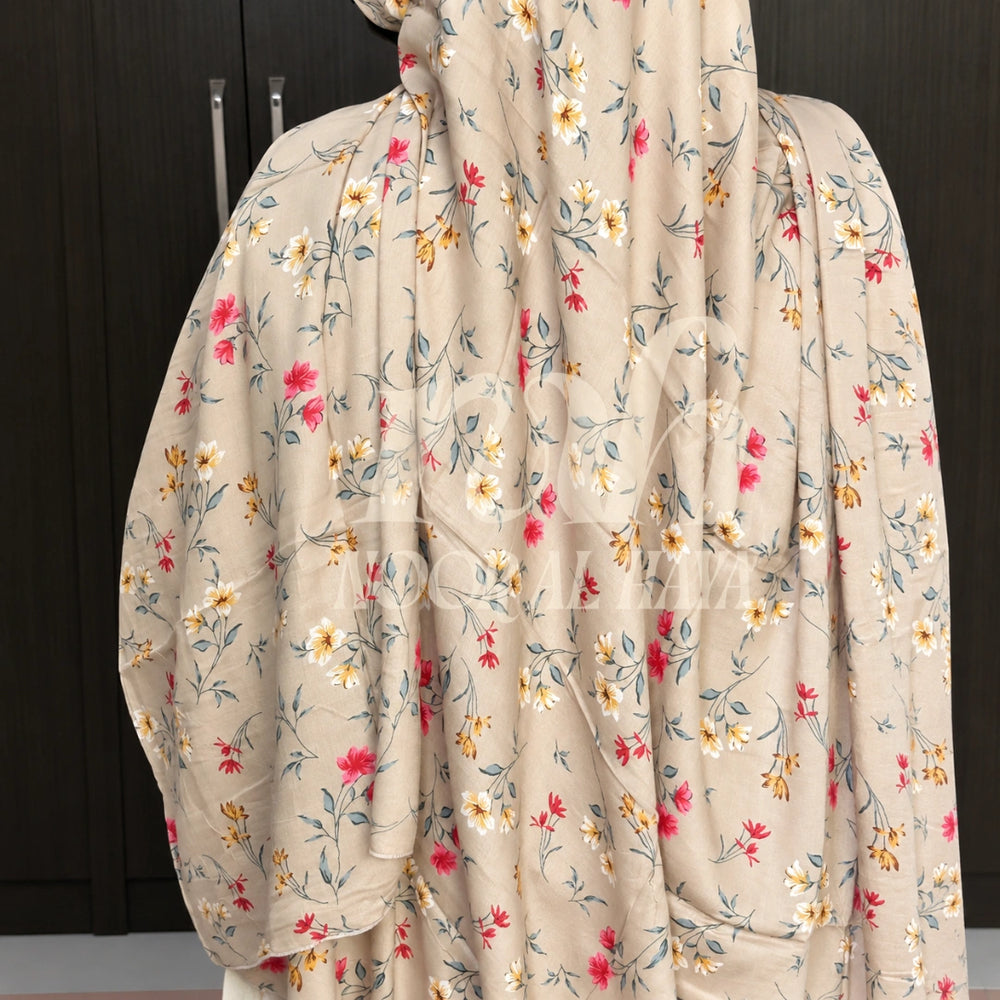 a model wearing ice white floral printed hijab by noor al haya