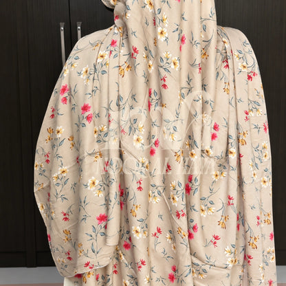 a model wearing ice white floral printed hijab by noor al haya