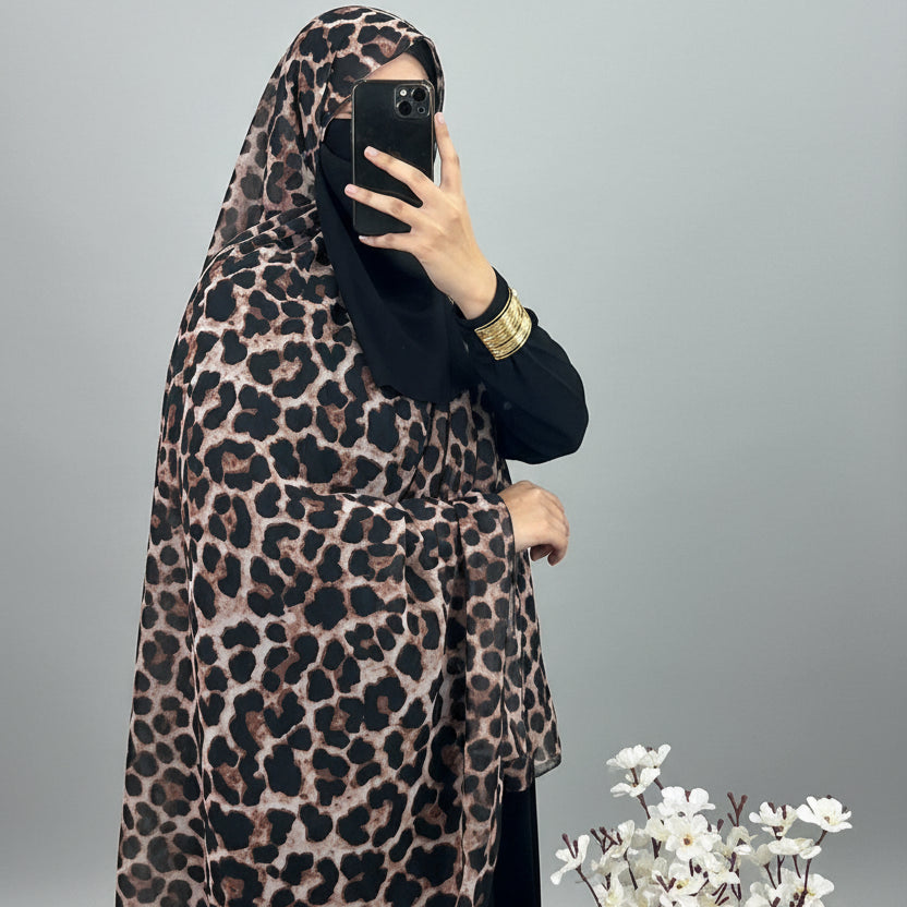 women wearing leopard chiffon print by noor al haya