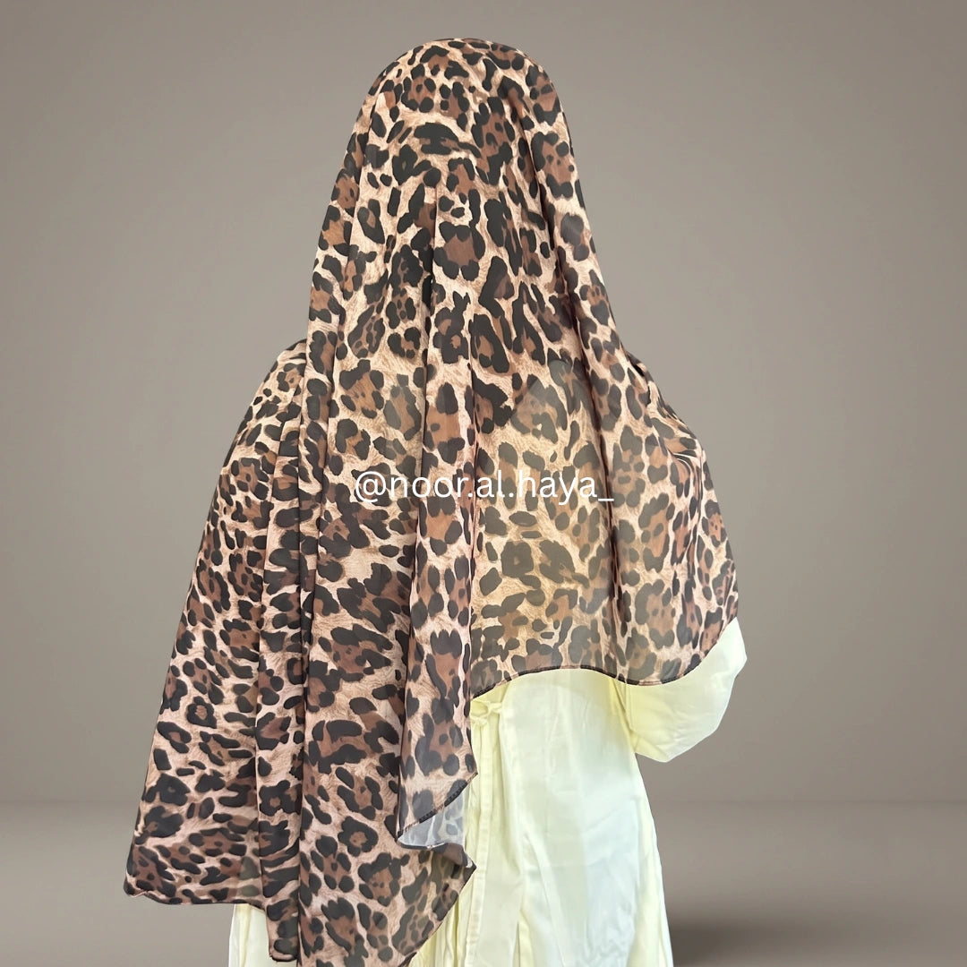 a women wearing leopard print chiffon hijab by noor al haya