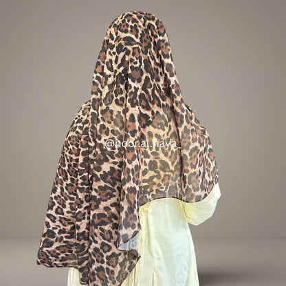 a women wearing leopard print chiffon hijab by noor al haya