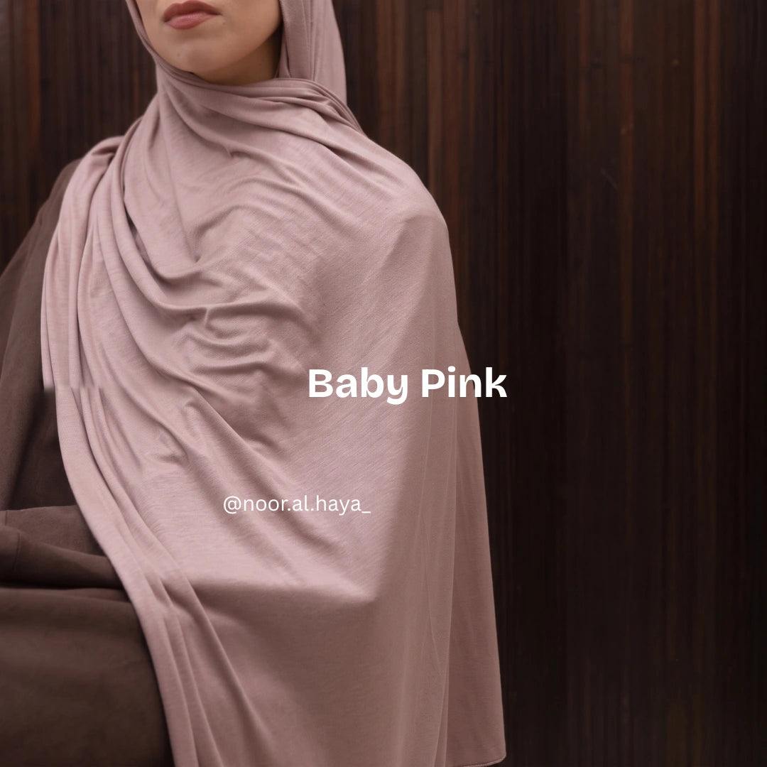 a women wearing baby pink luxe jersey hijab by noor al haya 