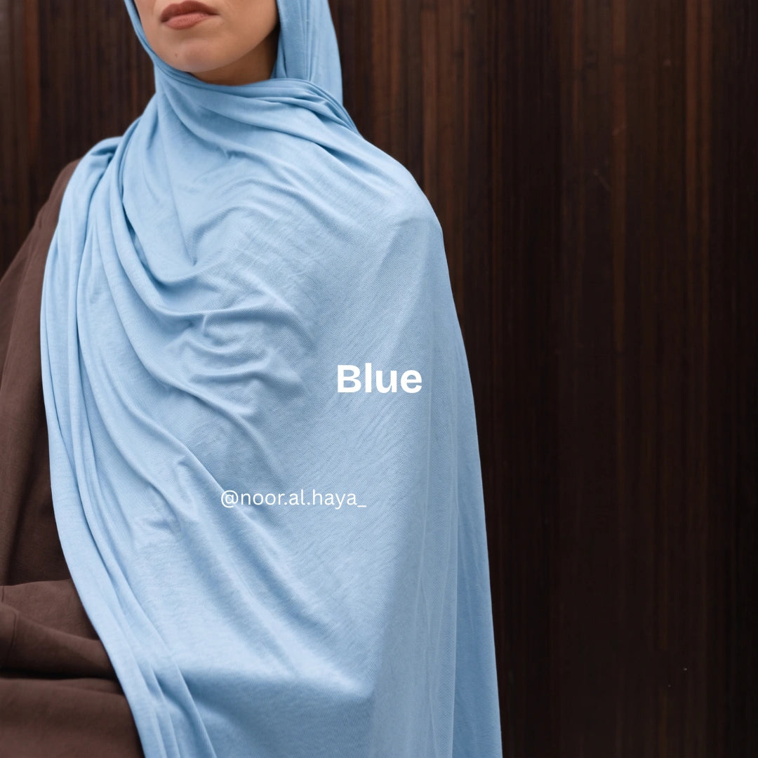 a women wearing a blue luxe jersey hijab by noor al haya 