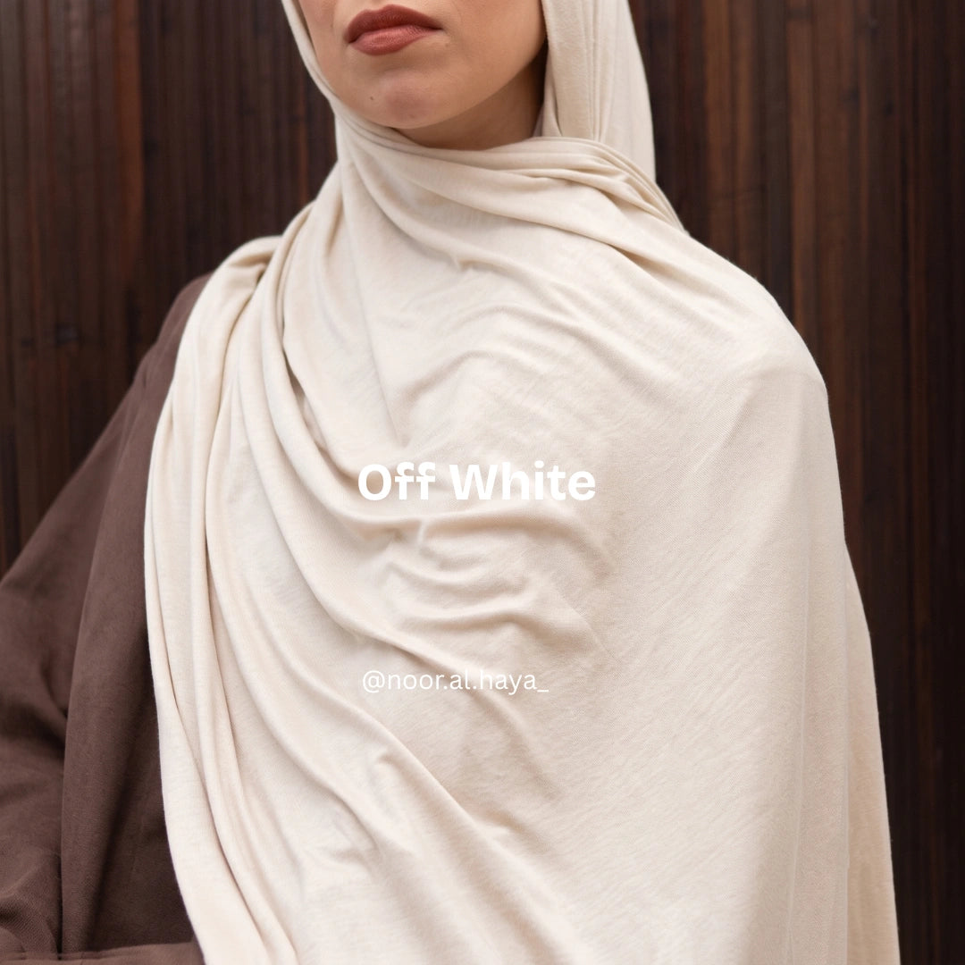 a women wearing a off white luxe jersey hijab by noor al haya