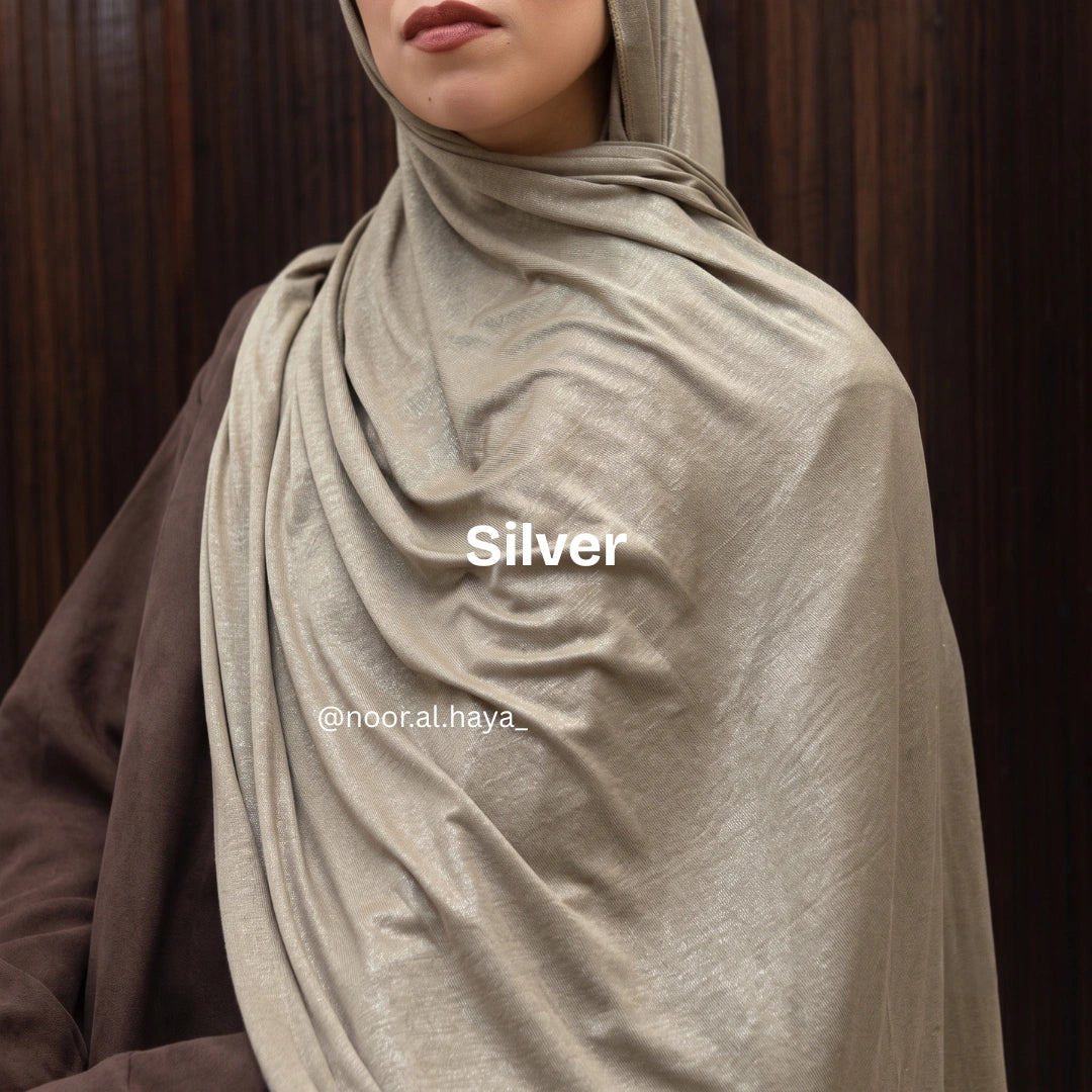 a women wearing silver luxe jersey hijab by noor al haya 