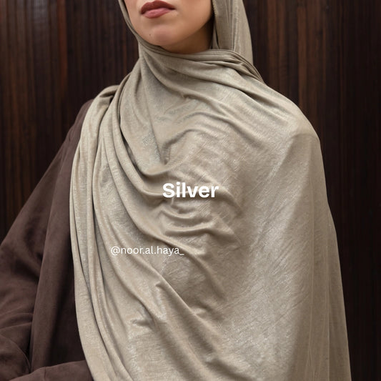 a women wearing silver luxe jersey hijab by noor al haya 