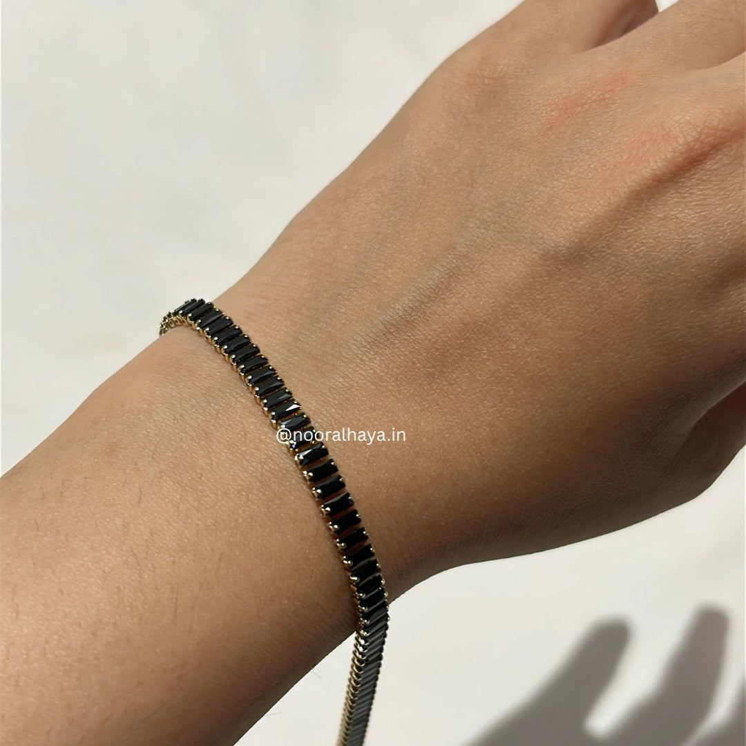 Woman wearing a black crystal tennis bracelet by Noor Al Haya