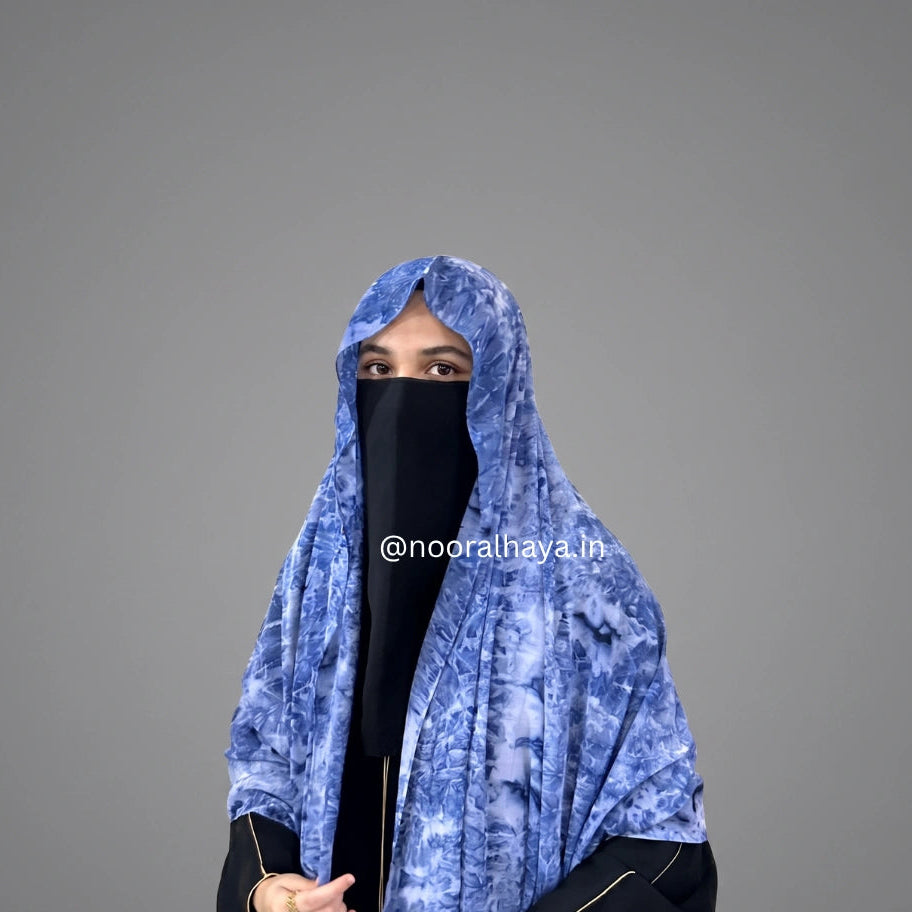 a model wearing Blue watercolour hijab by Noor Al Haya