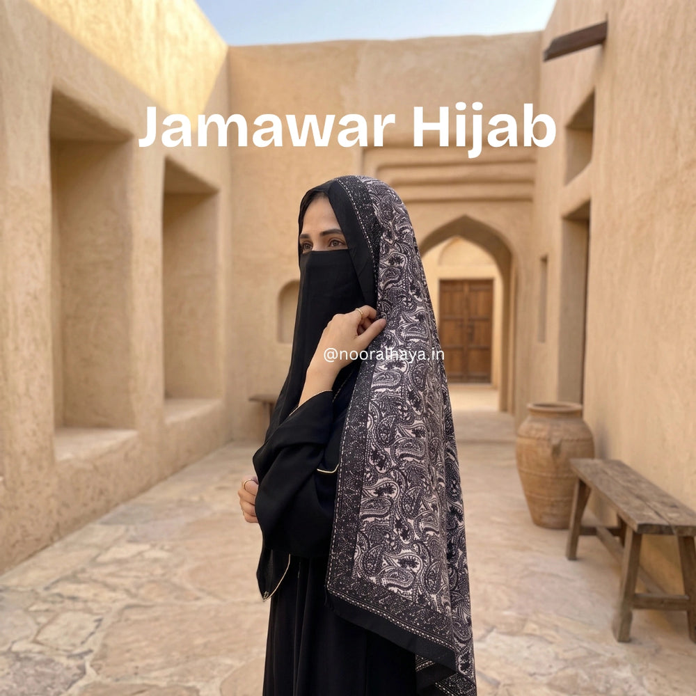 a model wearing black jamawar hijab by noor al haya