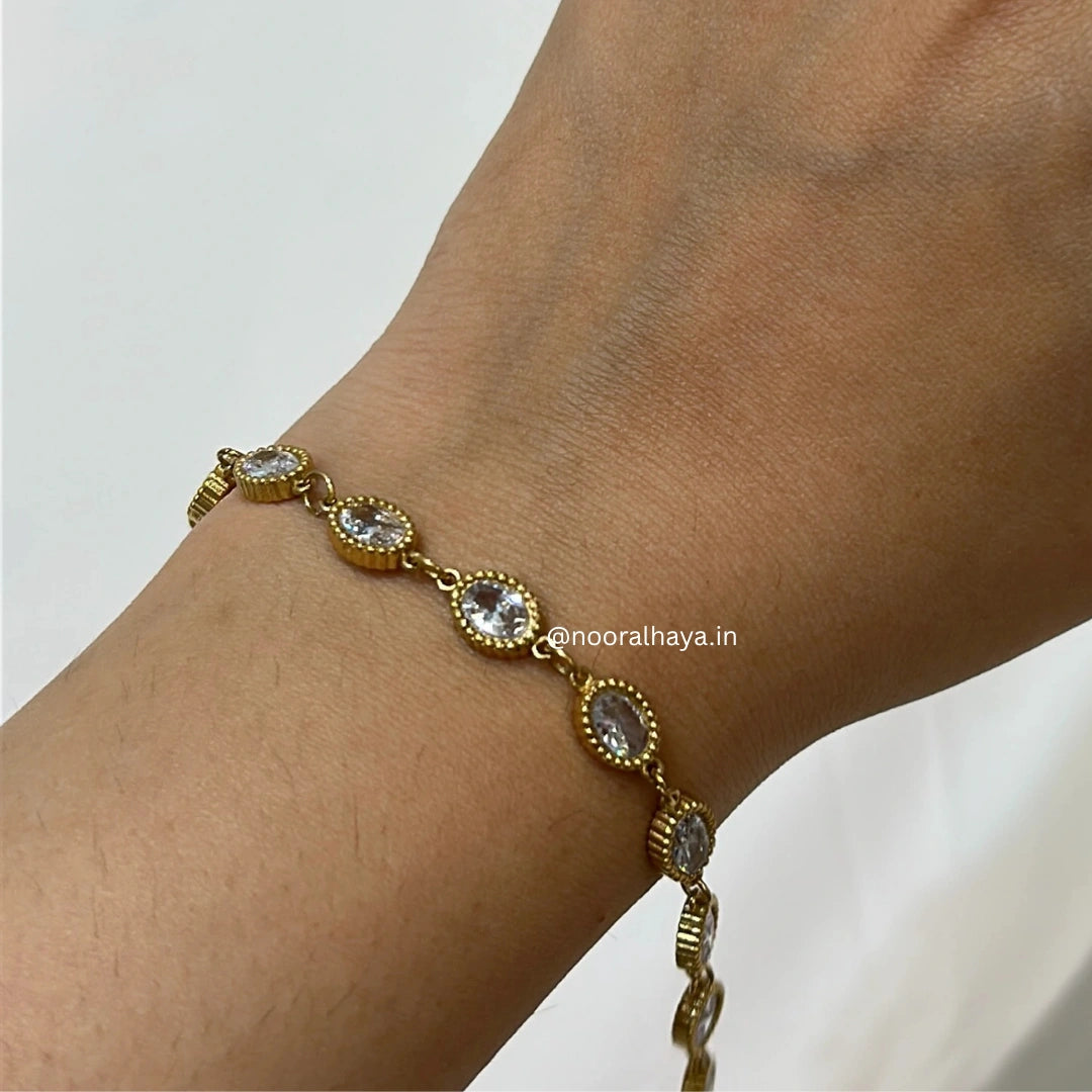 Woman wearing an oval crystal bracelet by Noor Al Haya