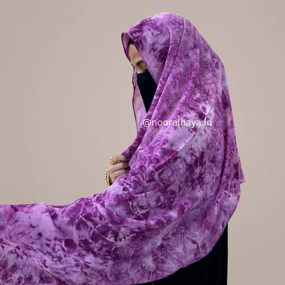 a women wearing pink watercolour hijab by noor al haya
