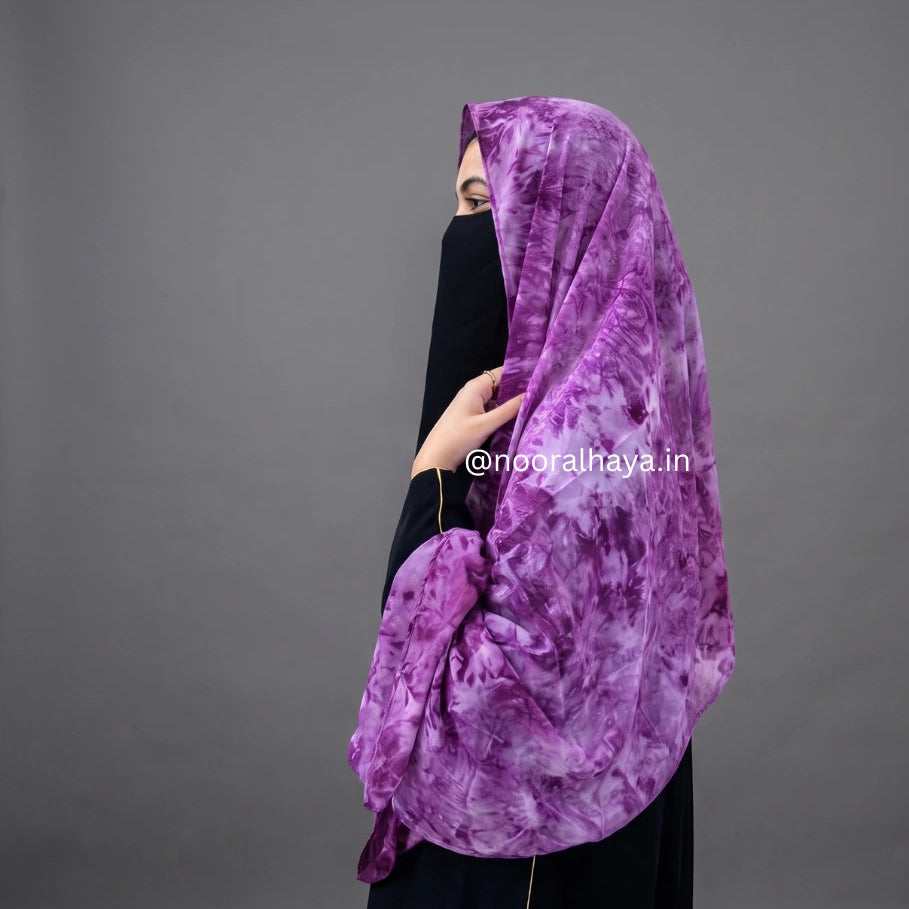 a women wearing pink watercolour hijab by noor al haya