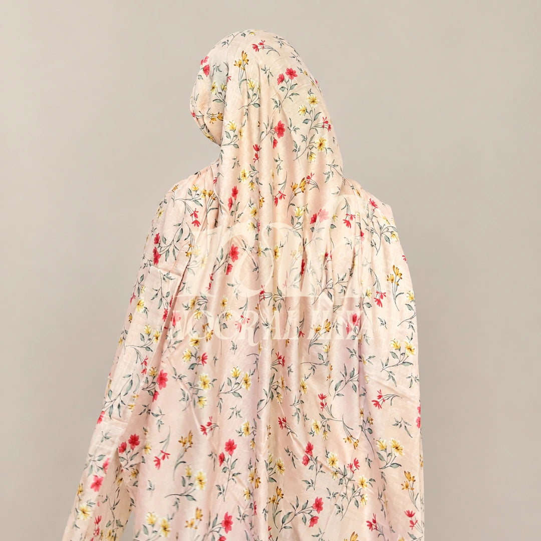 a  model wearing pink floral printed hijab by noor al haya