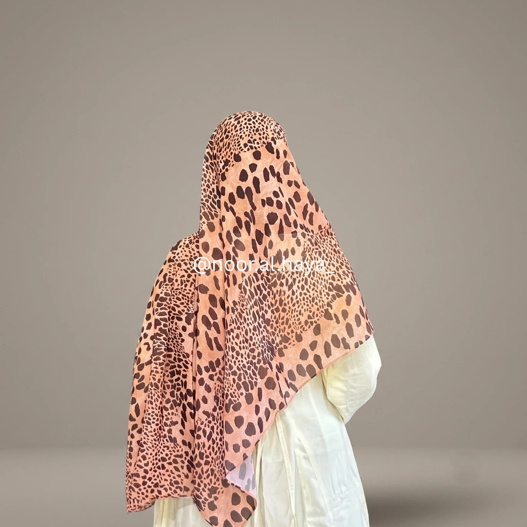 a women wearing savanna animal print hijab by noor al haya