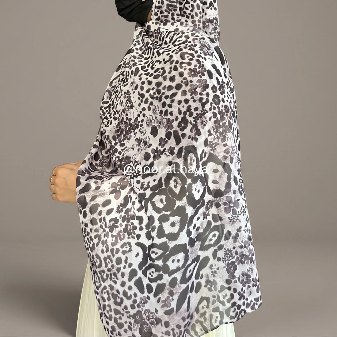 a women wear snow leopard print hijab by noor al haya
