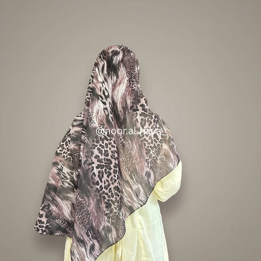A woman wearing a wildcat animal print hijab by noor al haya