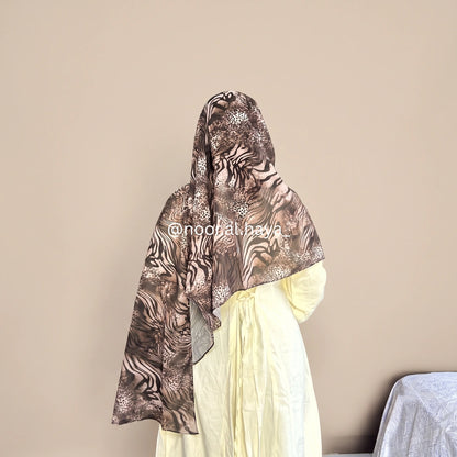 a women wearing zebra print chiffon hijab by noor al haya