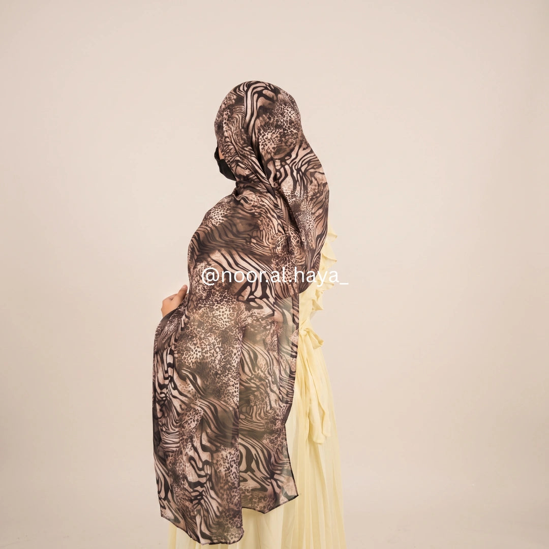 a women wearing zebra print chiffon hijab by noor al haya